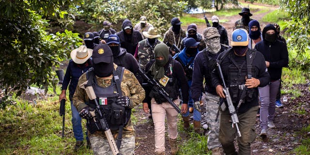 Members of the self-defense group Pueblos Unidos carry out guard duties to protect avocado plantations, whipped by drug cartels that dominate the area, in Ario de Rosales, Michoacan state, Mexico, on July 8, 2021. 