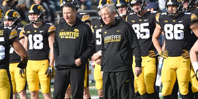 Iowa offensive coordinator Brian Ferentz and Iowa head coach Kirk Ferentz watch warm up drills before a college football game between the Illinois Fighting Illini and the Iowa Hawkeyes on Nov. 20, 2021, at Kinnick Stadium, Iowa City, Iowa.