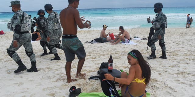 Members of the newly created Tourist Security Battalion of the National Guard patrol a beach in Cancun, Quintana Roo State, Mexico, on Dec. 2, 2021. On November 17, Mexico created a "tourist battalion" of 1,500 National Guard police officers to protect its popular Caribbean beaches in Cancun and Tulum from organized crime. The new unit began operations on December 1 in the area known as the Riviera Maya in Quintana Roo State, but authorities plan to eventually introduce similar battalions in other tourist hot-spots. The Riviera Maya and Yucatan peninsula are the main tourism areas in Mexico, the seventh-most visited country in the world.