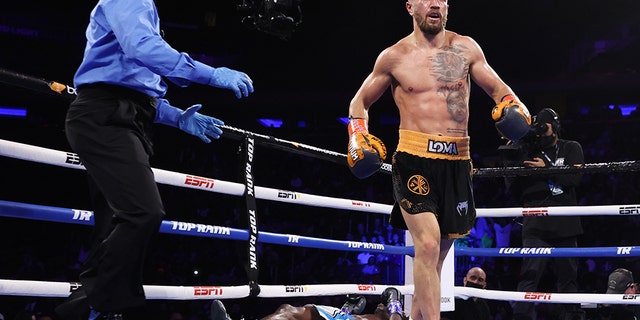 NEW YORK, NEW YORK - DECEMBER 11: Vasiliy Lomachenko, right, knocks-down Richard Commey, center, during their fight for the WBO intercontinental lightweight championship at Madison Square Garden on December 11, 2021 in New York City.