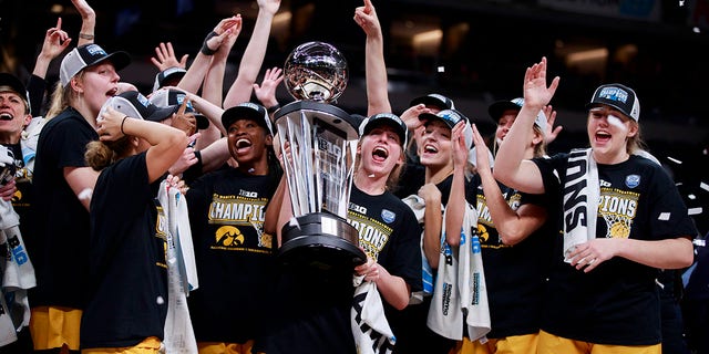 Iowa Hawkeyes celebrate after beating Indiana University to win the NCAA basketball Women's Big Ten Tournament championship in Indianapolis. Iowa beat Indiana University 74-67. 