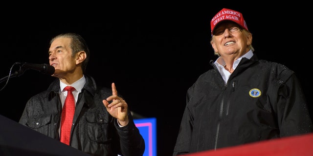 Senate candidate Mehmet Oz, who lost to John Fetterman Tuesday, joins former President Donald Trump onstage during a rally at the Westmoreland County Fairgrounds.