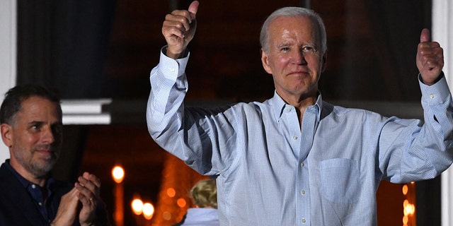 President Joe Biden gives two thumbs up from a balcony of the White House next to son Hunter Biden during 4th of July fireworks in Washington, DC, July 4, 2022.