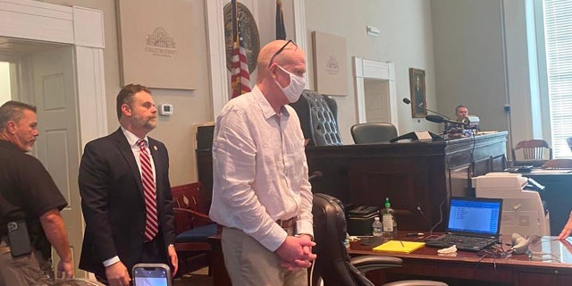 Once-prominent South Carolina attorney Alex Murdaugh, right, enters Colleton County court in South Carolina on July 20, 2022, for a bond hearing on murder charges. 