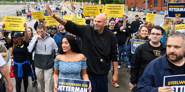 John Fetterman, lieutenant governor of Pennsylvania and Democratic senate candidate, center, and his wife Gisele Fetterman, center left, walk with the United Steelworkers District 10 union during a Labor Day parade in Pittsburgh, Pennsylvania, on Monday, Sept. 5, 2022. 
