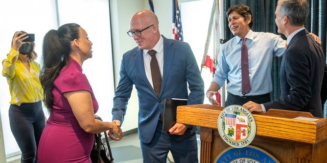 Left to right-Los Angeles City Council President Nury Martinez shakes hands with Matt Hewumhofer, an attorney representing L.A. Alliance as Los Angeles City Councilman Kevin de Léon talks with Los Angeles Mayor Eric Garcetti at conclusion of a press conference where it was announced that a $236 million settlement reached to bring services to people experiencing homelessness. 