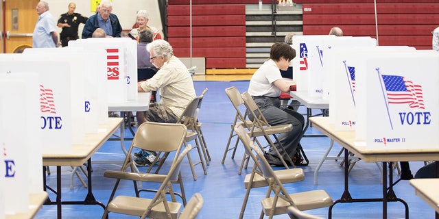 Voters fill out their ballots at Bedford High School during the primary on Sept. 13, 2022, in Bedford, New Hampshire.