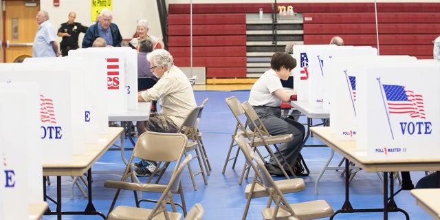 Voters fill out their ballots at Bedford High School during the primary on Sept. 13, 2022, in Bedford, New Hampshire.