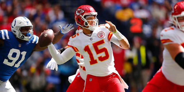 Kansas City Chiefs quarterback Patrick Mahomes (15) gets a pass away under pressure from Indianapolis Colts defensive end Yannick Ngakoue (91) during a game Sept. 25, 2022, at Lucas Oil Stadium in Indianapolis. 