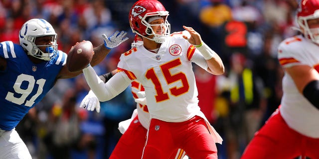 Kansas City Chiefs quarterback Patrick Mahomes (15) gets a pass away under pressure from Indianapolis Colts defensive end Yannick Ngakoue (91) during a game Sept. 25, 2022, at Lucas Oil Stadium in Indianapolis. 