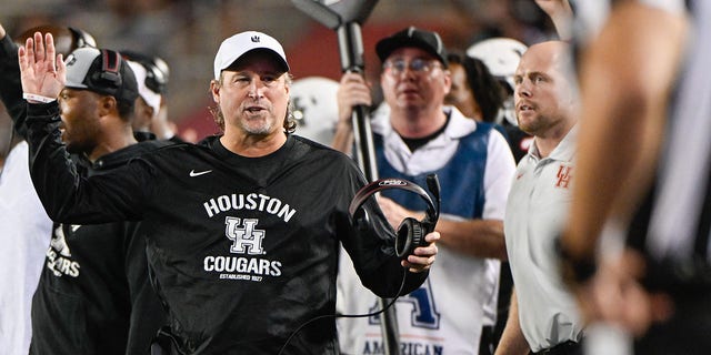 Houston Cougars head coach Dana Holgorsen pleads his case with the official after the Cougars were called for pass interference during the overtime period during the football game between the Tulane Green Wave and Houston Cougars at TDECU Stadium on September 30, 2022, in Houston, TX. 