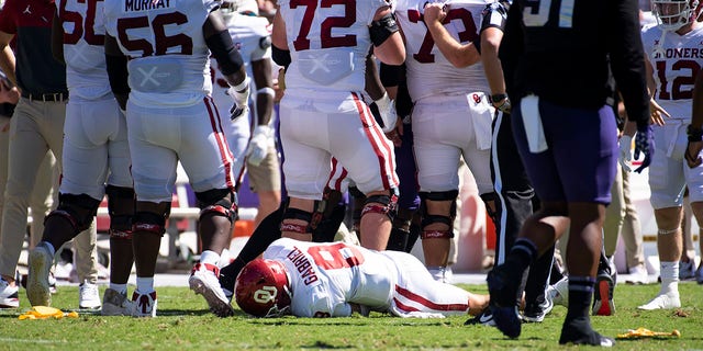 Quarterback Dillon Gabriel (8) of the Oklahoma Sooners lies on the field after taking a hit from linebacker Jamoi Hodge of the TCU Horned Frogs in the second quarter at Amon G. Carter Stadium Oct. 1, 2022, in Fort Worth, Texas. Hodge was disqualified from the game. 