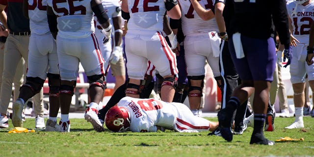 Quarterback Dillon Gabriel (8) of the Oklahoma Sooners lies on the field after taking a hit from linebacker Jamoi Hodge of the TCU Horned Frogs in the second quarter at Amon G. Carter Stadium Oct. 1, 2022, in Fort Worth, Texas. Hodge was disqualified from the game.