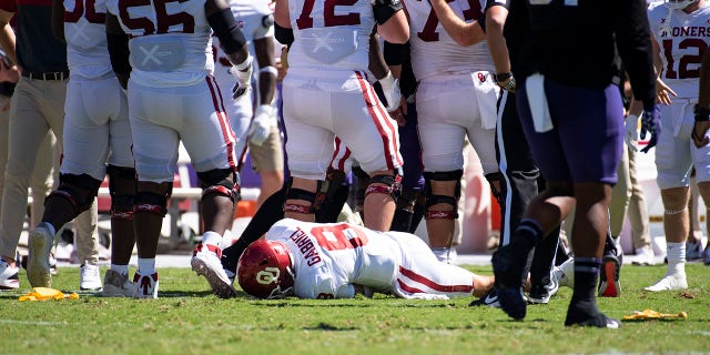 Quarterback Dillon Gabriel (8) of the Oklahoma Sooners lies on the field after taking a hit from linebacker Jamoi Hodge of the TCU Horned Frogs in the second quarter at Amon G. Carter Stadium Oct. 1, 2022, in Fort Worth, Texas. Hodge was disqualified from the game. 