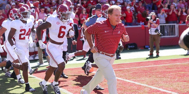 Alabama coach Nick Saban leads his team onto the field for the game between the Arkansas Razorbacks and the Alabama Crimson Tide on October 01, 2022 at Donald W. Reynolds Razorback Stadium in Fayetteville, AR