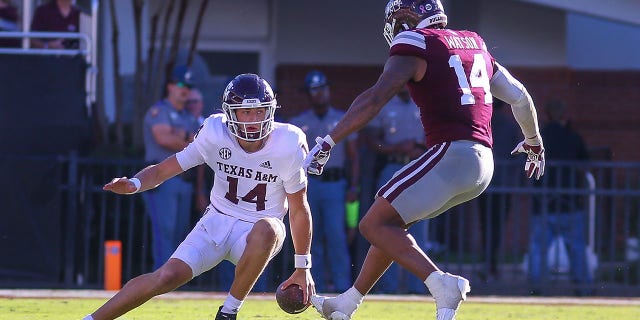 Texas A and M Aggies quarterback Max Johnson, 14, cuts back during a game against the Mississippi Bulldogs at Davis Wade Stadium in Starkville, Mississippi, on Oct. 1, 2022. 