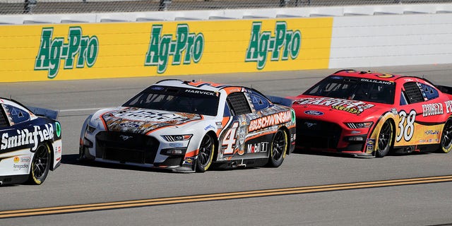 Todd Gilliland (#38 Front Row Motorsports Georgia Peanuts Ford) pressures Kevin Harvick (#4 Stewart Haas Racing Busch Light Ford Mustang) during the running of the Yellawood 500 NASCAR Cup Series Playoff race on Oct. 2, 2022 at the Talladega Superspeedway in Lincoln, Alabama.