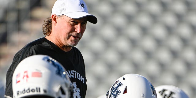 Houston Cougars Head Coach Dana Holgolssen chats with team members before the Tulane Green Wave vs. Houston Cougars football game at TDECU Stadium in Houston, Texas on September 30, 2022. 