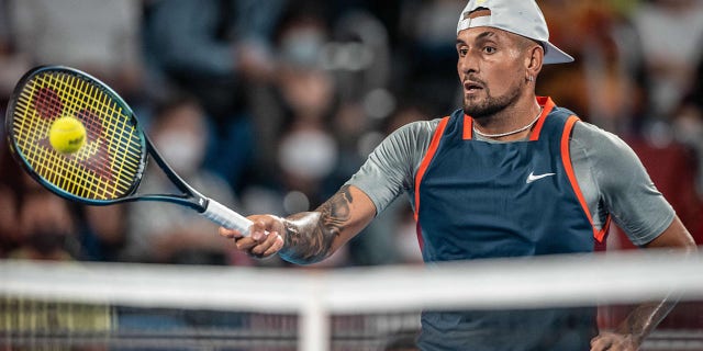 Nick Kyrgios returns a ball against Tseng Chun-hsin