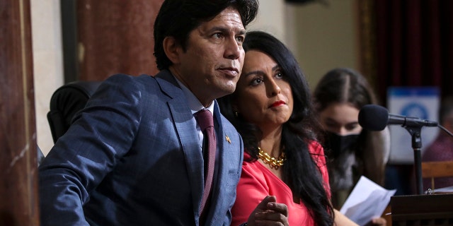 Los Angeles Councilman Kevin de León, left, and then-Los Angeles City Council President Nury Martinez confer at an Oct. 4 city council meeting. 