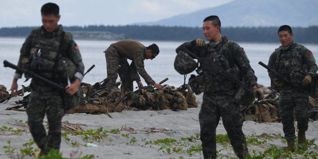 Südkorea (Vordergrund) und US-Marines nehmen an einer gemeinsamen amphibischen Landungsübung mit ihren philippinischen Kollegen an einem Strand mit Blick auf das Südchinesische Meer in San Antonio, Provinz Zambales, am 7. Oktober 2022, teil. 