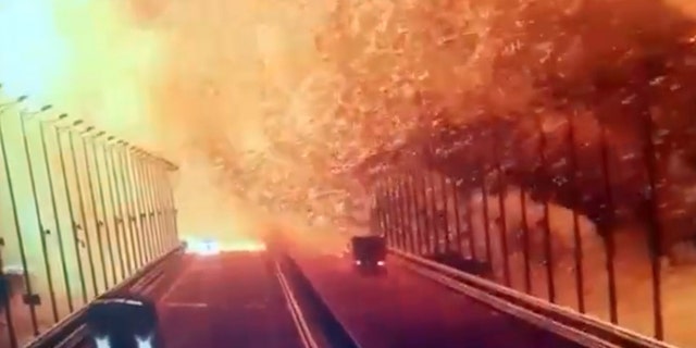 A screen grab from a surveillance footage shows flames and smoke rising up after an explosion at the Kerch bridge (aka the Crimean Bridge) in the Kerch Strait, Crimea, Oct. 8, 2022. 