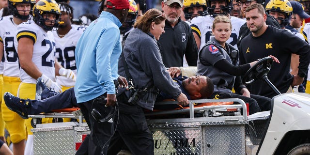Michigan Wolverines running back coach Mike Hart is carted off of the field during the first half against the Indiana Hoosiers at Memorial Stadium on October 8, 2022 in Bloomington, Indiana.