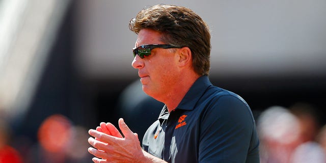 Oklahoma State Cowboys Head coach Mike Gundy cheers on his team as he walks onto the field for a game against the Texas Tech Red Raiders at Boone Pickens Stadium on Oct. 8, 2022 in Stillwater, Oklahoma.   