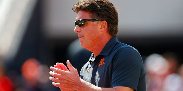 Oklahoma State Cowboys Head coach Mike Gundy cheers on his team as he walks onto the field for a game against the Texas Tech Red Raiders at Boone Pickens Stadium on Oct. 8, 2022 in Stillwater, Oklahoma.