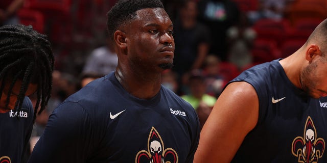 Zion Williamson, #1 of the New Orleans Pelicans, stands for the National Anthem before the preseason game against the Miami Heat on Oct. 12, 2022 at FTX Arena in Miami.