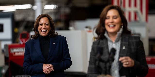 Vice President Kamala Harris smiles as Michigan Gov. Gretchen Whitmer delivers remarks after touring a FOCUS: HOPE facility on Saturday, Oct. 15, 2022 in Detroit.