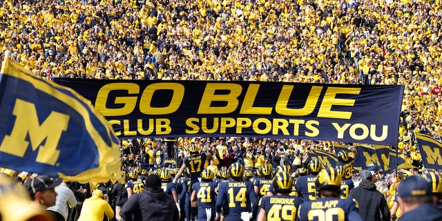 Michigan Wolverines players run onto the field before a game against the Penn State Nittany Lions Oct. 15, 2022, at Michigan Stadium in Ann Arbor, Mich. 