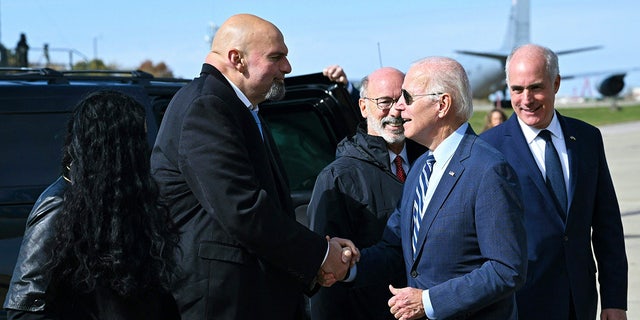 President Joe Biden is greeted by Pennsylvania Lt. Gov. and Democratic Senate candidate John Fetterman upon arrival at Pittsburgh International Airport in Pittsburgh, Pennsylvania, on October 20, 2022.