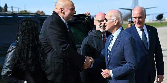 President Biden, right, is greeted by then-Pennsylvania Lt. Gov. and Democratic senatorial candidate John Fetterman upon arrival at Pittsburgh International Airport in Pittsburgh on Oct. 20, 2022.