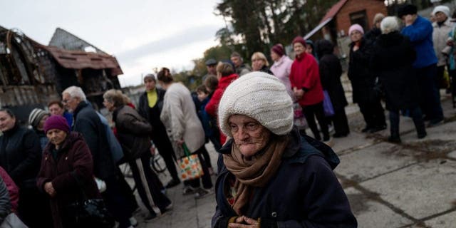 Ukrainian civilians queue for humanitarian aid provided by the Red Cross as people try to survive amid the wave of Russia's missile strikes in Sviatohiersk, Donetsk Oblast, Ukraine on Oct. 20, 2022. 
