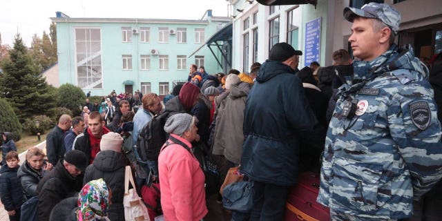 People arriving from Kherson await further evacuation into the depths of Russia at the Dzhankoi railway station in Crimea on October 21, 2022.