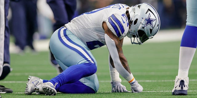 Dallas Cowboys running back Ezekiel Elliott gets up slowly after being hit during the game against the Detroit Lions on Oct. 23, 2022, in Arlington, Texas.