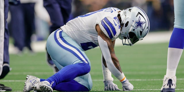 Dallas Cowboys running back Ezekiel Elliott gets up slowly after being hit during the game against the Detroit Lions on Oct. 23, 2022, in Arlington, Texas.