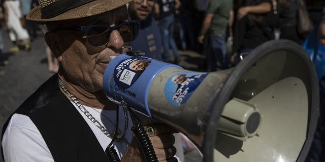 Supporters of Benjamin Netanyahu take part in a demonstration on October 28 in support of the former prime minister.  Voters go to the polls on November 1 to decide on the immediate political future of 