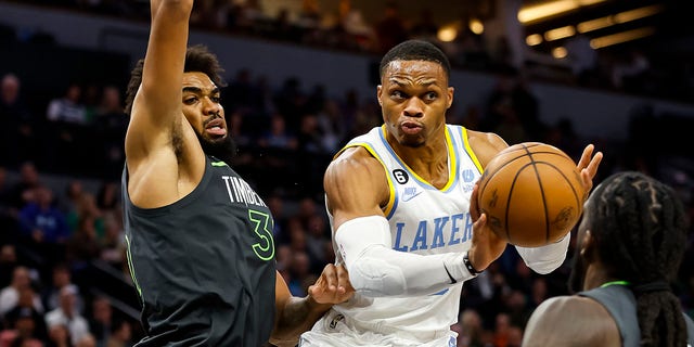 Russell Westbrook of the Los Angeles Lakers, center, passes the ball while Karl-Anthony Towns of the Minnesota Timberwolves, left, defends in the third quarter of a game at Target Center Oct. 28, 2022, in Minneapolis. The Timberwolves defeated the Lakers 111-102. 