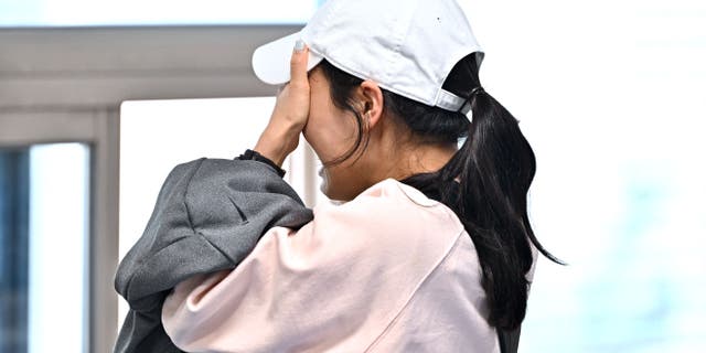 A relative of missing persons following Itaewon's Halloween stampede reacts as she awaits updates at Seoul's Hannam-dong Community Center.  JUNG YEON-JE / AFP via Getty Images)