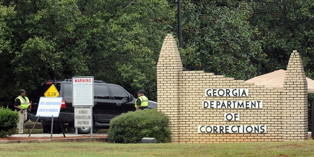 This file photo shows Georgia Department of Corrections officers check a vehicle at the entrance to the Georgia Diagnostic and Classification Prison in Jackson, Georgia, on September 21, Sept. 20, 2011. 