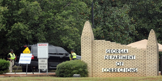 This file photo shows Georgia Department of Corrections officers check a vehicle at the entrance to the Georgia Diagnostic and Classification Prison in Jackson, Georgia, on September 21, Sept. 20, 2011.
