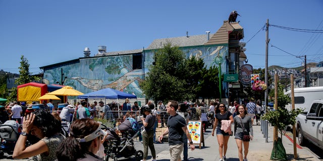 Festival-goers walk along 24th Street as during the 10th annual Noe Valley neighborhood SummerFEST in the Noe Valley Town Square Sunday, June 23, 2019, in San Francisco, Calif. 