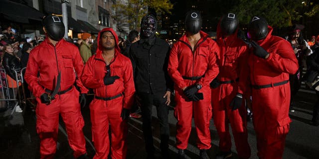 Netflix’s "Squid Game" is still a top-searched-for costume for 2022, according to the Halloween and Costume Association. Pictured is a group of people wearing pink and black jumpsuits from "Squid Game" during New York City’s 48th Annual Village Halloween Parade on Oct. 31, 2021.