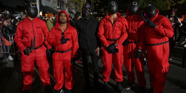 Netflix’s "Squid Game" is still a top-searched-for costume for 2022, according to the Halloween and Costume Association. Pictured is a group of people wearing pink and black jumpsuits from "Squid Game" during New York City’s 48th Annual Village Halloween Parade on Oct. 31, 2021.