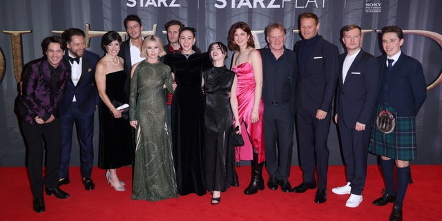 (L to R) Alexander Vlahos, Richard Rankin, Maril Davis, Cesar Domboy, Lauren Lyle, Steven Cree, Sophie Skelton, Jessica Reynolds, Caitlin O'Ryan, Mark Lewis Jones, Sam Heughan, Euan Bennet and Paul Gorman attend the "Outlander" Season Six Premiere at The Royal Festival Hall on Feb. 24, 2022 in London, England.