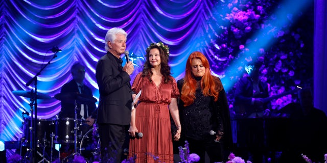 Larry Strickland, Naomi's husband, appeared on stage with Naomi's daughters Ashley and Wynonna during CMT and Sandbox Live's "Naomi Judd: A River Of Time Celebration" at the Ryman Auditorium in May.