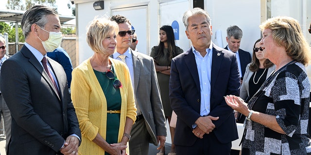 This file image shows Attorney General Rob Bonta, Supervisor Janice Hahn, LA County Public Defender Ricardo García, and Assemblymember Al Muratsuchi listening to Shari Weaver, Director of the Coordinated Entry System for Harbor Interfaith, operator of the Tiny Home Village as she gave them a guided tour of the facility, in Torrance on Monday, September 12, 2022. 