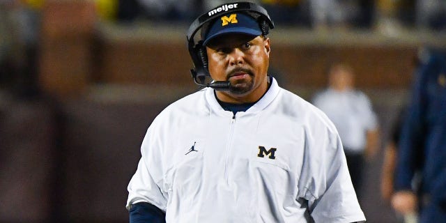 Blake Corum #2 (L) and Assistant Coach Mike Hart (R) of the Michigan Wolverines are seen during the second half of a college football game against the Hawaii Rainbow Warriors at Michigan Stadium on Sept. 10, 2022 in Ann Arbor, Michigan. The Michigan Wolverines won the game 56-10 over the Hawaii Rainbow Warriors.